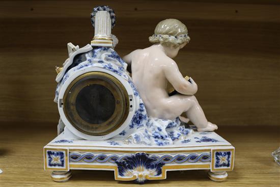 A late 19th century Meissen eight day mantel clock, surmounted by a cherub and objects emblematic of the arts